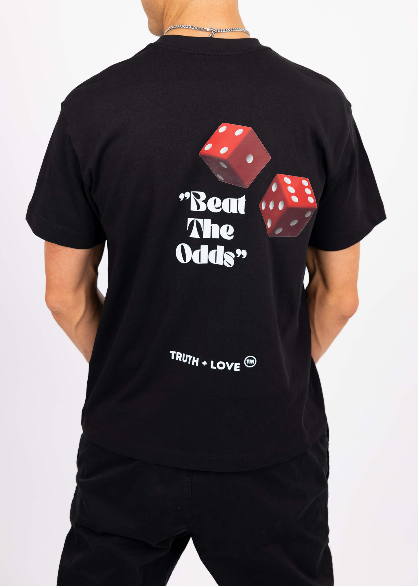 "Bold 'Beat the Odds' T-shirt with a striking dice design on the back, made in the UK from 100% organic cotton, 240 GSM for ultimate comfort and quality."