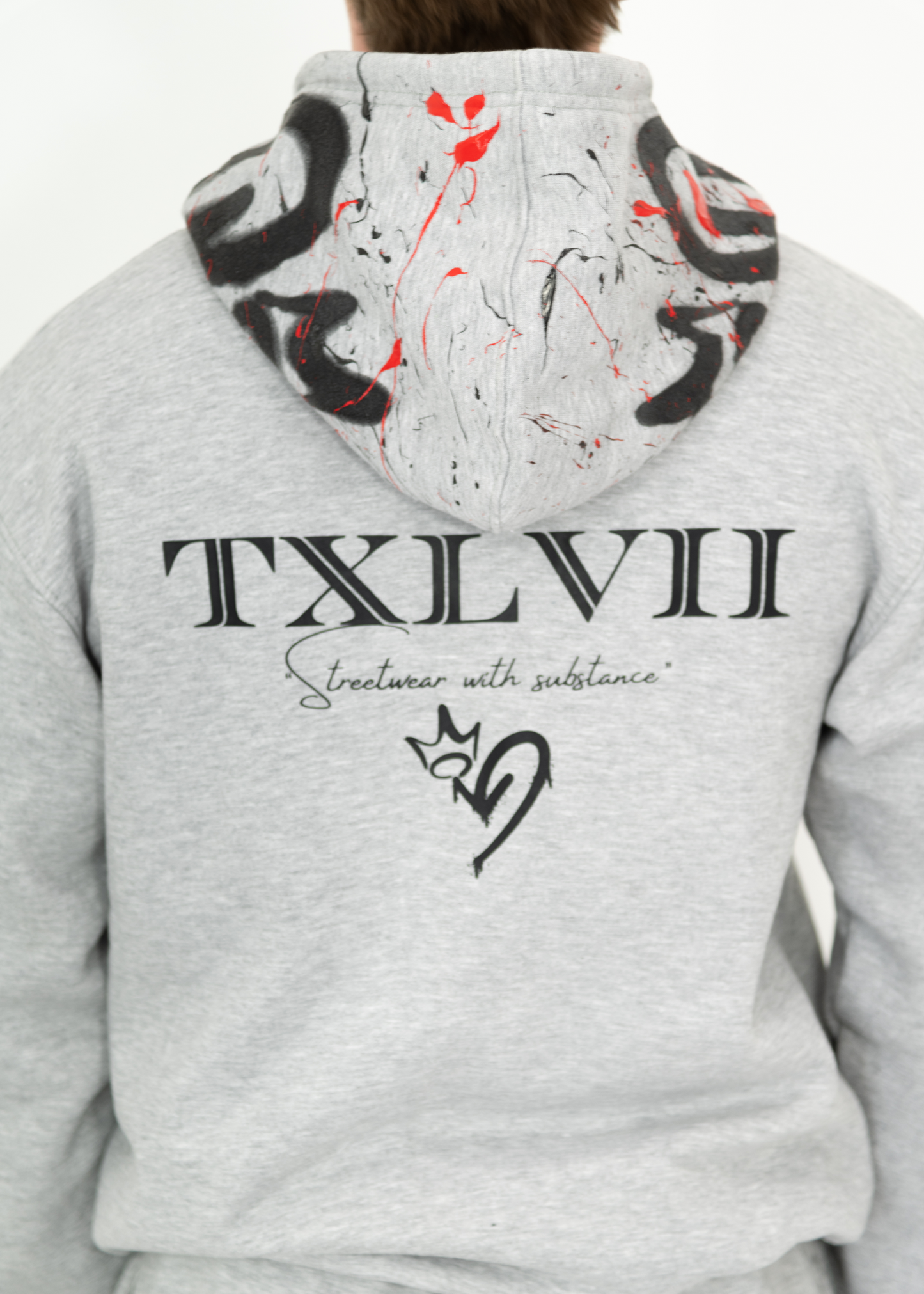 Grey custom-made hoodie worn by a model, designed by brand TXLVII and handcrafted in Newcastle upon Tyne, UK, showcasing premium UK-made streetwear.