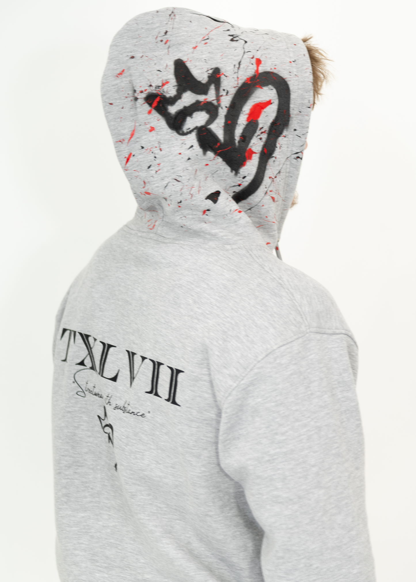 Grey custom-made hoodie worn by a model, designed by brand TXLVII and handcrafted in Newcastle upon Tyne, UK, showcasing premium UK-made streetwear.