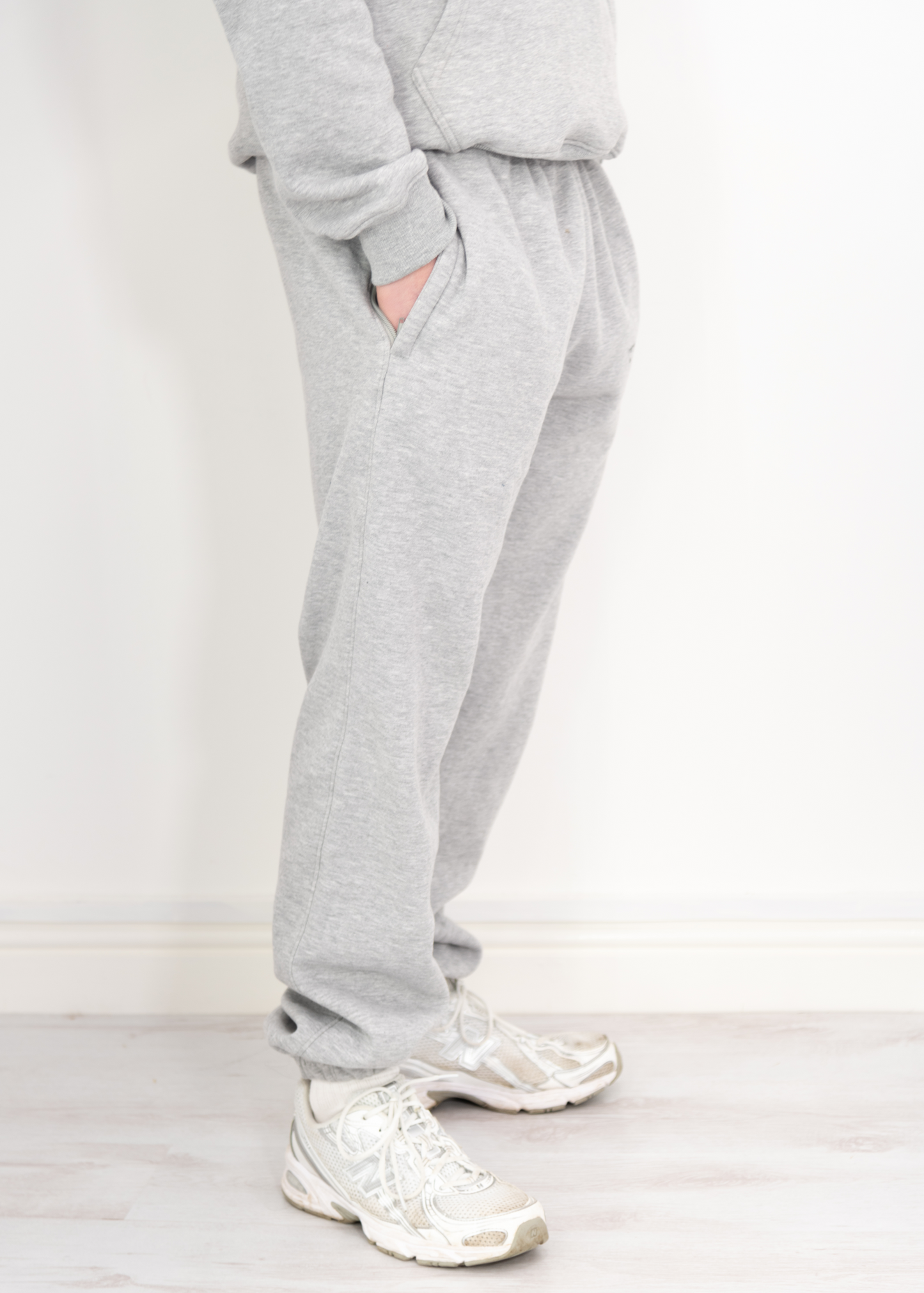 "Model wearing grey joggers designed by TXLVII, UK-made streetwear handcrafted in Newcastle upon Tyne, featuring a minimalist fit and premium fabric.