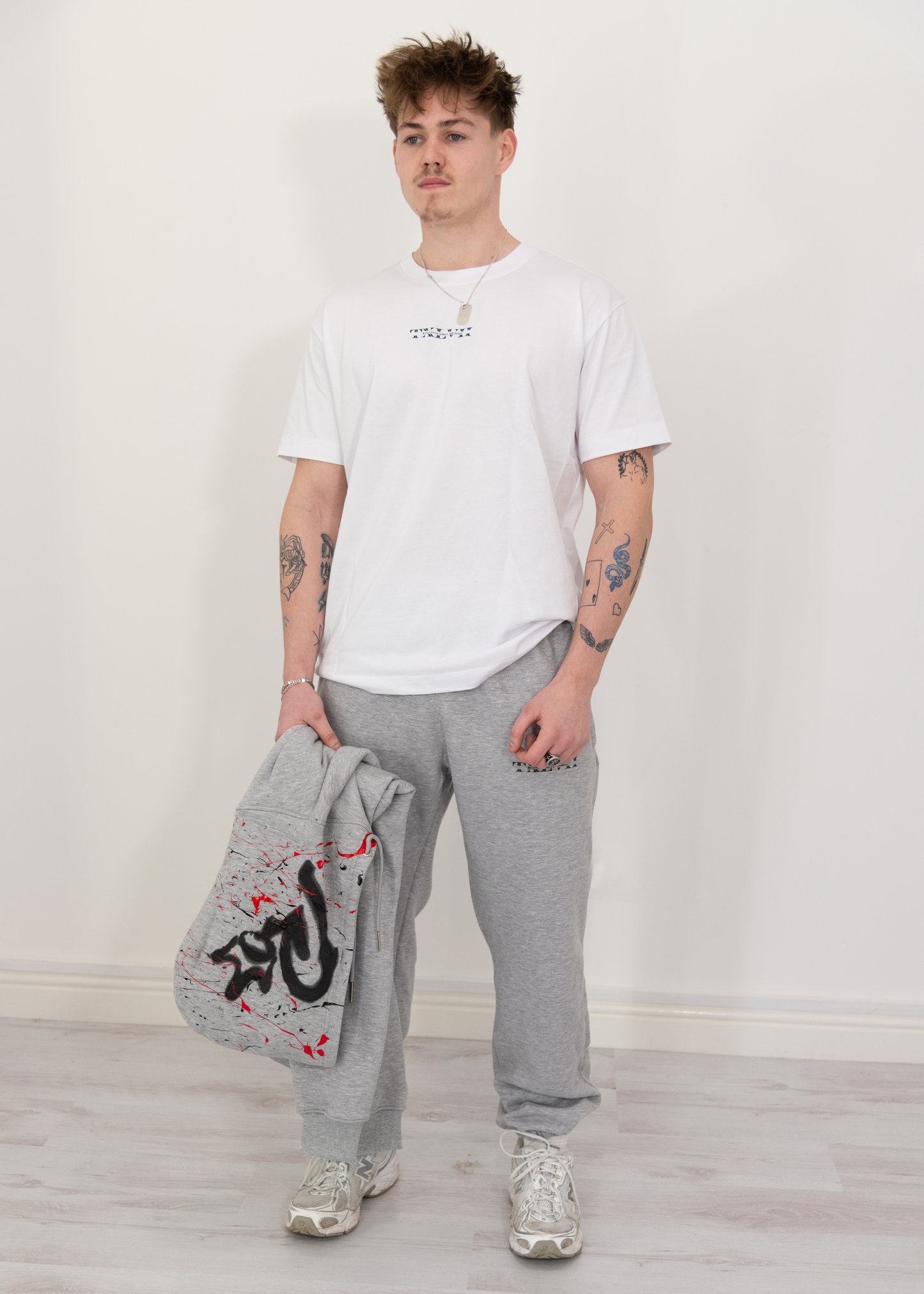 "Model wearing grey joggers designed by TXLVII, UK-made streetwear handcrafted in Newcastle upon Tyne, featuring a minimalist fit and premium fabric.