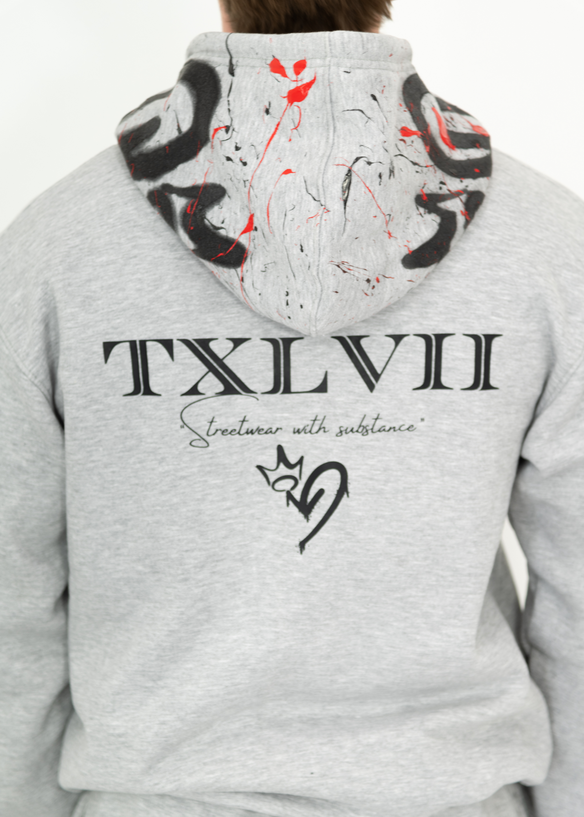 Grey custom-made hoodie worn by a model, designed by brand TXLVII and handcrafted in Newcastle upon Tyne, UK, showcasing premium UK-made streetwear.