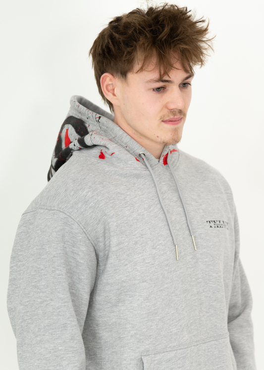 Grey custom-made hoodie worn by a model, designed by brand TXLVII and handcrafted in Newcastle upon Tyne, UK, showcasing premium UK-made streetwear.