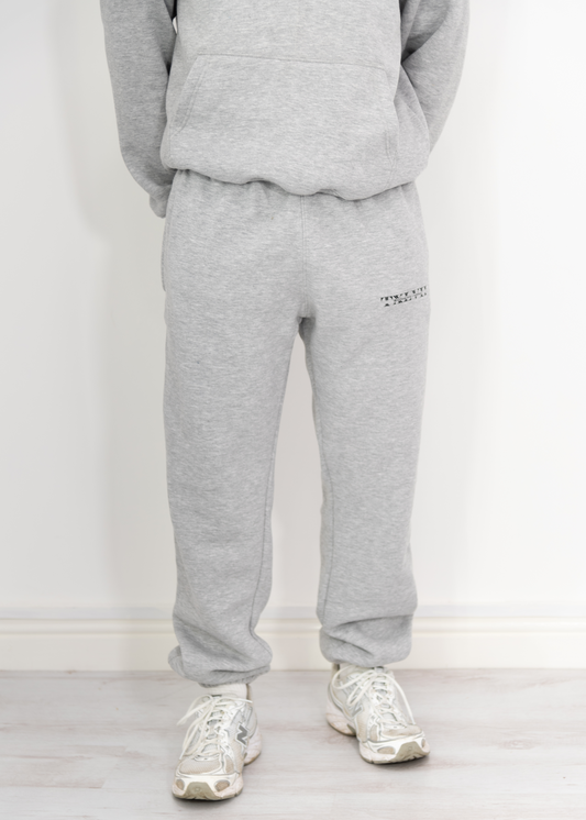 "Model wearing grey joggers designed by TXLVII, UK-made streetwear made in Newcastle upon Tyne, featuring a minimalist fit and premium fabric.