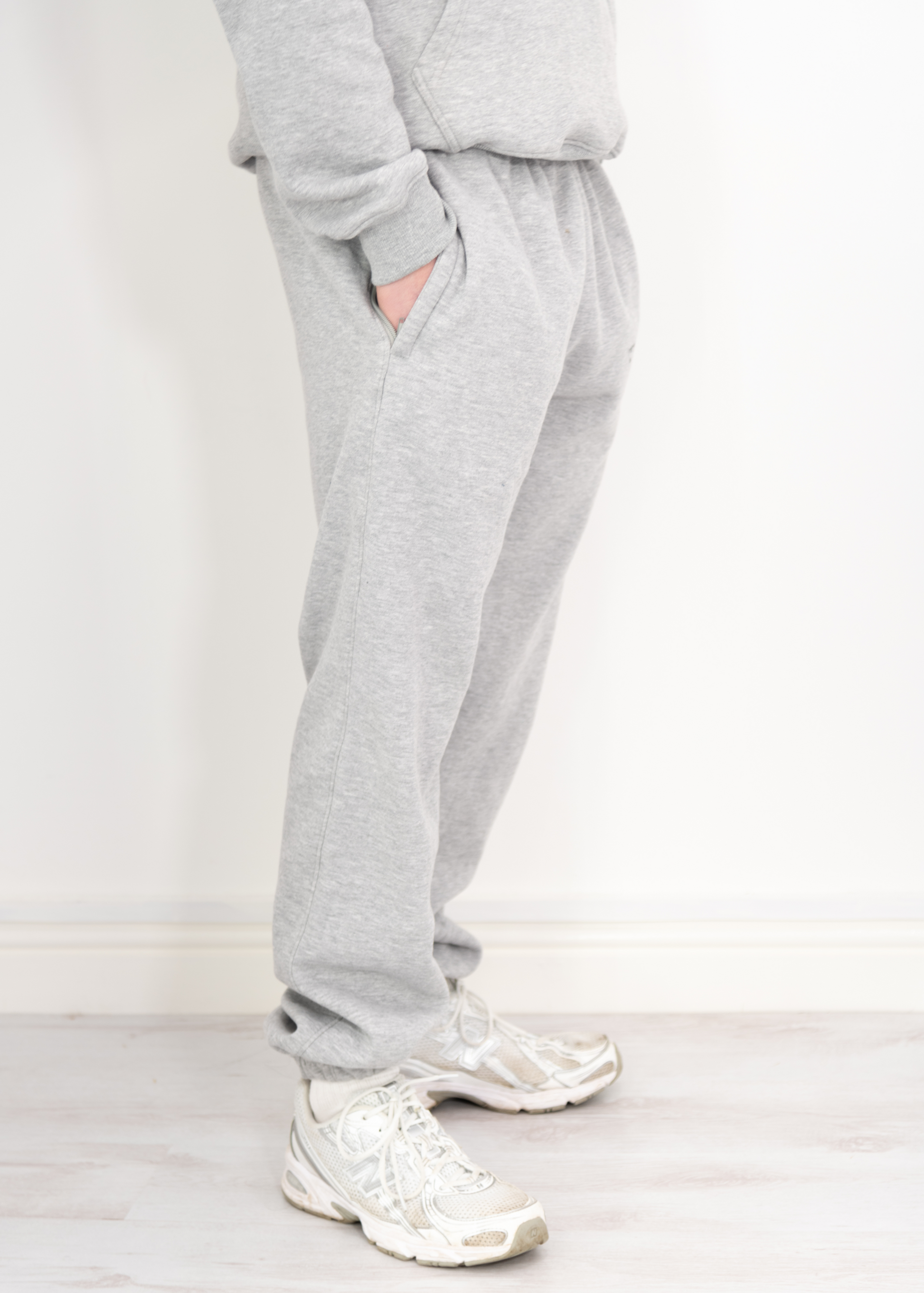 "Model wearing grey joggers designed by TXLVII, UK-made streetwear handcrafted in Newcastle upon Tyne, featuring a minimalist fit and premium fabric.